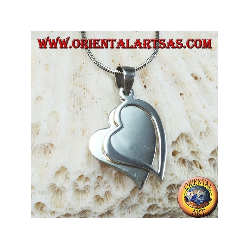 Silver pendant with two hearts, one of which is pierced