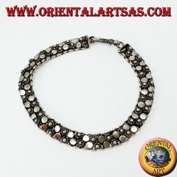 Silver bracelet with two rows of small flowers and round plates