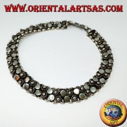 Silver bracelet with two rows of small flowers and round plates