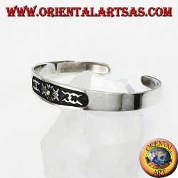 Silver cuff bracelet with central low relief carving