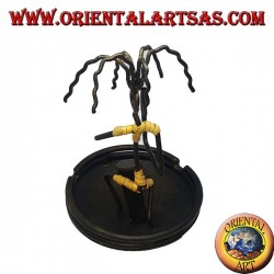 Burning incense, wrought iron ashtray, the percussionist