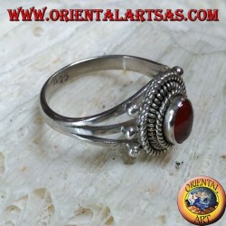 Silver ring with carnelian cabochon surrounded by three serpentine threads