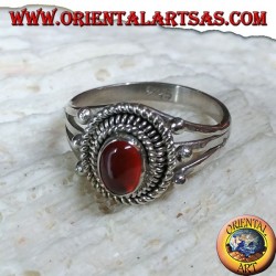 Silver ring with carnelian cabochon surrounded by three serpentine threads