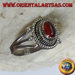 Silver ring with carnelian cabochon surrounded by three serpentine threads