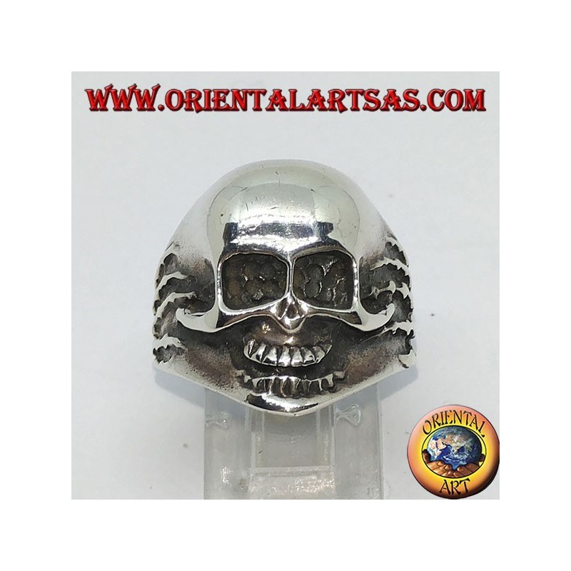 Ring in silver skull in hands