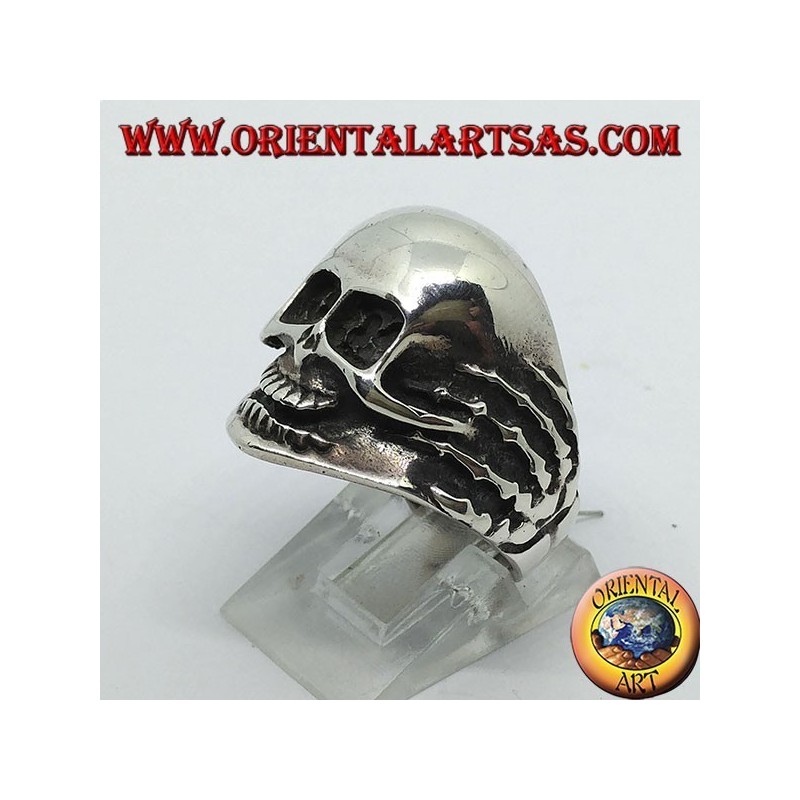 Ring in silver skull in hands
