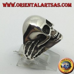 Ring in silver skull in hands