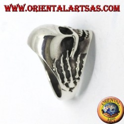 Ring in silver skull in hands