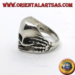 Ring in silver skull in hands