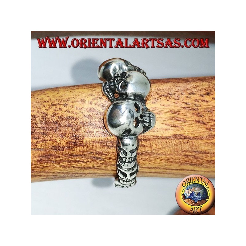 Silver ring with three skulls with bone