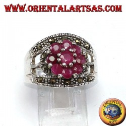 Silver band ring with a flower set with 9 round rubies set