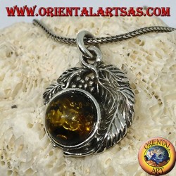 Silver pendant with a hemispherical amber between the leaves