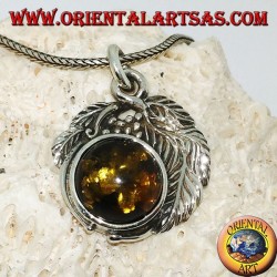 Silver pendant with a hemispherical amber between the leaves