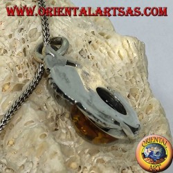 Silver pendant with a hemispherical amber between the leaves