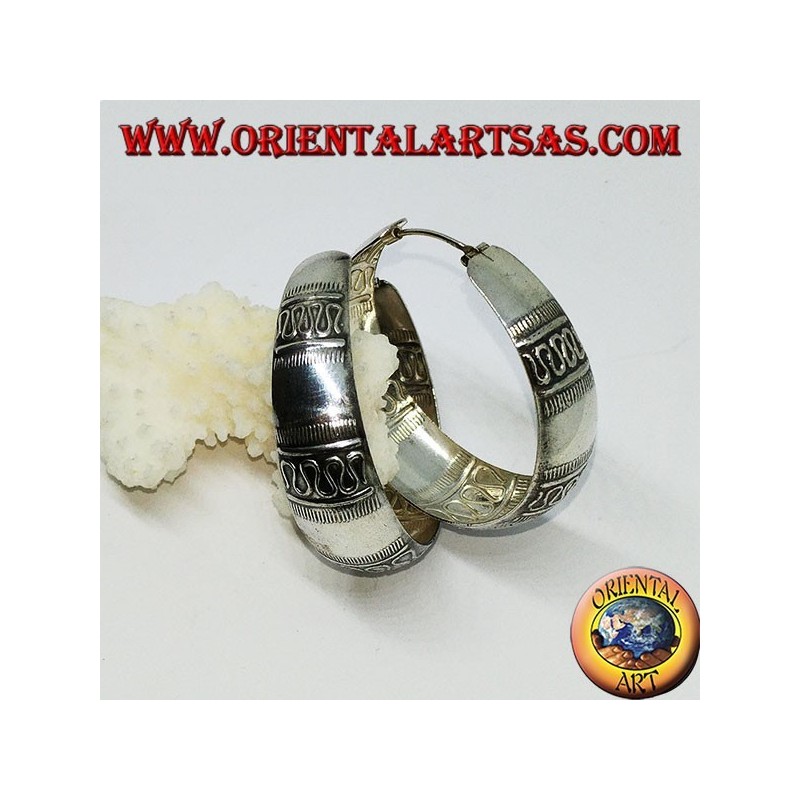 Silver earrings with a round wide-rimmed ring with transverse wave decoration