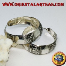 Silver earrings with a round wide-rimmed ring with transverse wave decoration