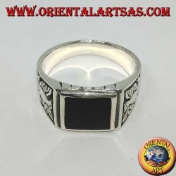 Anillo de plata con ónix rectangular y águilas en bajorrelieve en ambos lados.