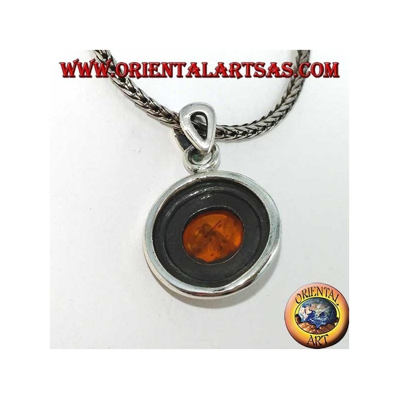 Silver pendant with a round amber, and two-wax edge