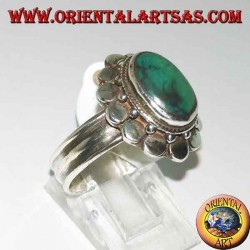 Silver ring with natural antique oval turquoise, edged with round plates