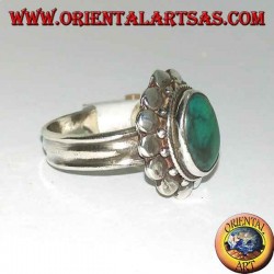 Silver ring with natural antique oval turquoise, edged with round plates