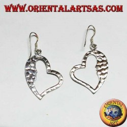 Hammered silver heart-shaped earrings with a striking face on the inside