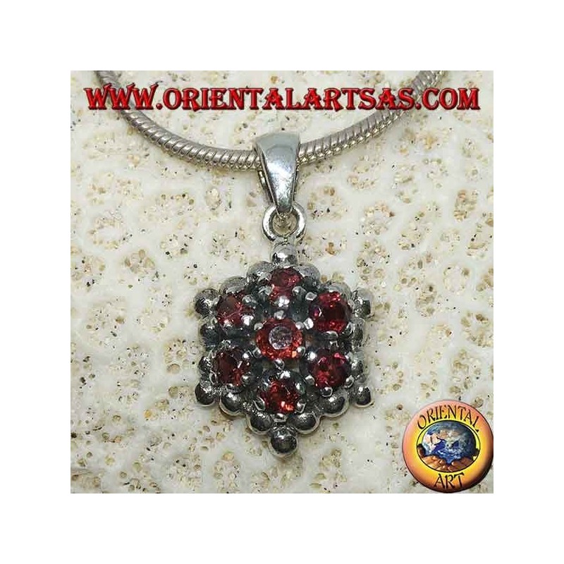 Hexagonal silver pendant made up of 7 round garnets surrounded by silver spheres