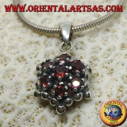 Hexagonal silver pendant made up of 7 round garnets surrounded by silver spheres