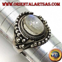 Silver ring with oval rainbow moonstone with asymmetrical ball decorations