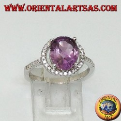 Silver ring with natural amethyst suspended on a circle of zircons