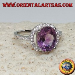 Silver ring with natural amethyst suspended on a circle of zircons