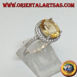 Silver ring with natural topaz suspended on a circle of zircons