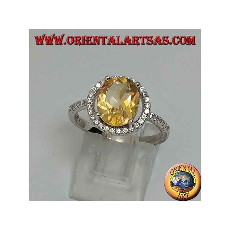 Silver ring with natural topaz suspended on a circle of zircons