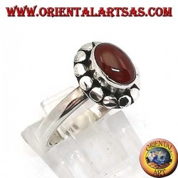 Silver ring with oval cabochon carnelian surrounded by studs
