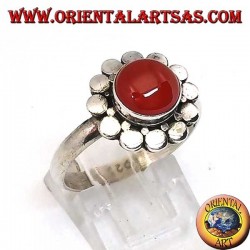 Silver ring with a round cabochon carnelian surrounded by studs