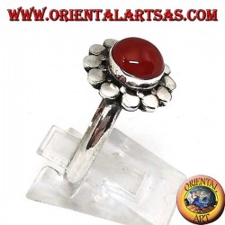 Silver ring with a round cabochon carnelian surrounded by studs