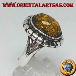 Silver ring with green oval amber surrounded by studs