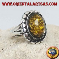Silver ring with green oval amber surrounded by studs
