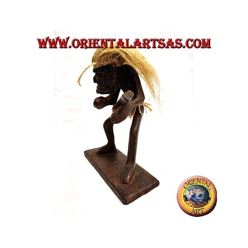 Sculpture of a primitive man guitarist in teak wood