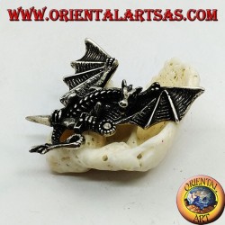 Pendentif dragon en argent avec ailes déployées et poignard entre les griffes
