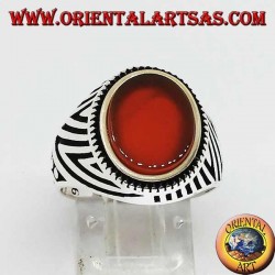 Silver ring with flat oval carnelian and engravings engraved on the sides