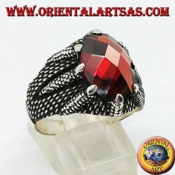 Silver ring with oval faceted garnet set by the claws