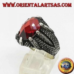Silver ring with oval faceted garnet set by the claws