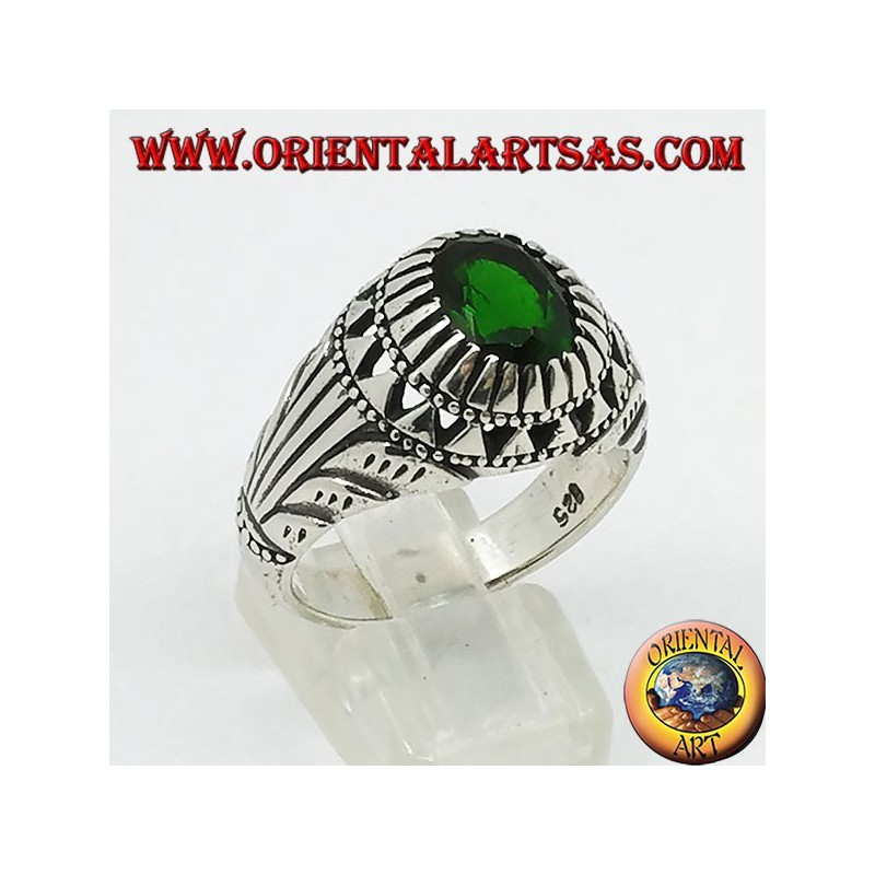 Silver ring with emerald-colored oval zircon set and carvings on the sides