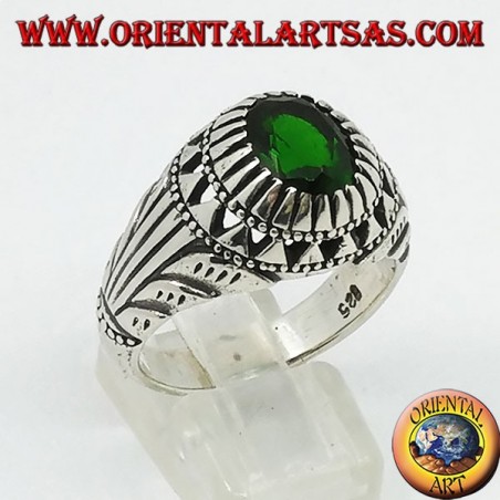 Silver ring with emerald-colored oval zircon set and carvings on the sides