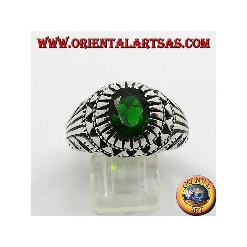 Silver ring with emerald-colored oval zircon set and carvings on the sides