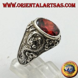 Silver ring with oval faceted garnet and stylized dragon in high relief on the sides