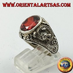 Silver ring with oval faceted garnet and stylized dragon in high relief on the sides