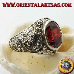 Silver ring with oval faceted garnet and stylized dragon in high relief on the sides