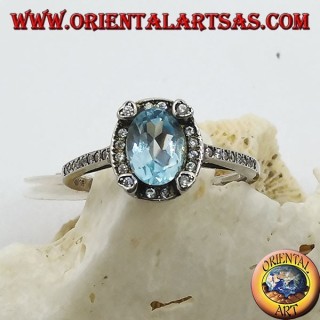 Silver ring with natural oval blue topaz set surrounded by zircons