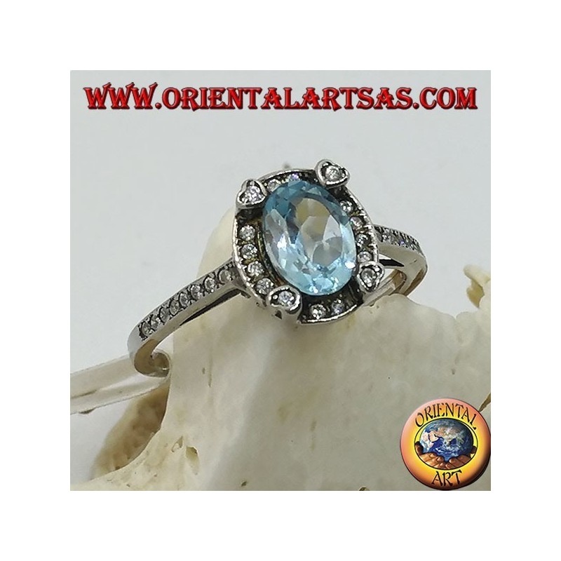 Anillo de plata con topacio azul oval natural engastado en circonitas.